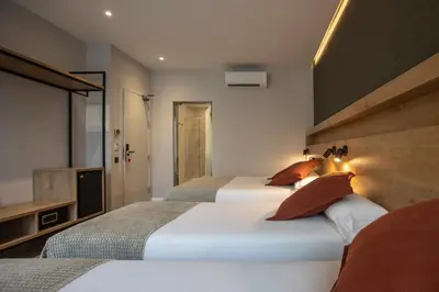 a bedroom with two beds and a television in it at Fontanella By BCN URBAN Rooms in Barcelona