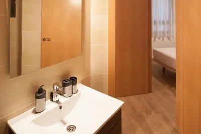 a bathroom with a white sink and a mirror at Casa Codina in Barcelona