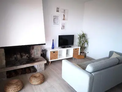 a living room with a couch and a tv at ÁTICO FRENTE AL MAR in Canet de Mar