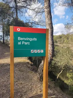 a sign for the entrance to a park at L'aviador de Can Ton in Sant Llorenc Savall
