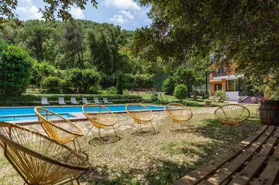 a group of chairs sitting in front of a pool at L'aviador de Can Ton in Sant Llorenc Savall