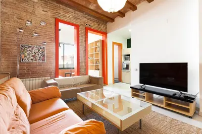 a living room with a couch and a tv at Moianes Apartment by Olala Homes in Barcelona