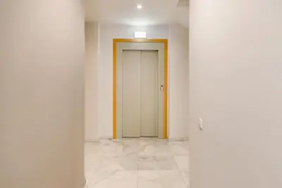 an empty hallway with a door in a room at Sitges in centrum close to the beach in Sitges