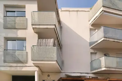 an apartment building with balconies on the side of it at Sitges in centrum close to the beach in Sitges
