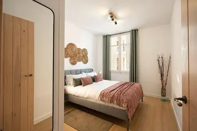 a bedroom with a bed and a mirror at Charming 2br In Trendy Gracia in Barcelona