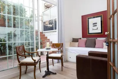 a living room with a bed and a table and chairs at Luxury 4bdr In Gracia in Barcelona