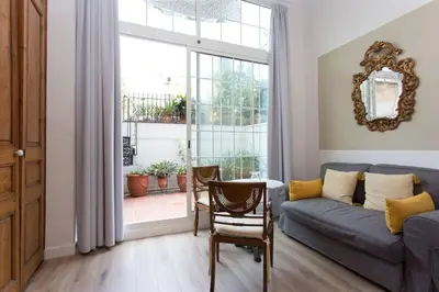 a living room with a couch and a window at Luxury 4bdr In Gracia in Barcelona