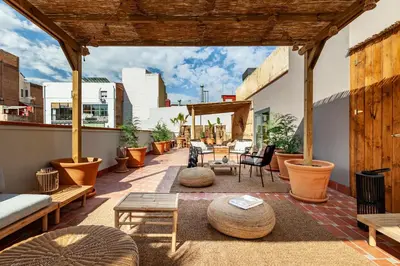 a patio with a lot of furniture and plants at BENI - 1 bedroom apartment with pool and terrace in Gracia in Barcelona