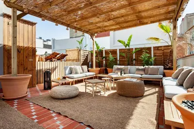 a bedroom with a large bed and a desk at BENI - 1 bedroom apartment with pool and terrace in Gracia in Barcelona