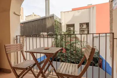 a table and two chairs sitting on a balcony at Housalia Gracia in Barcelona