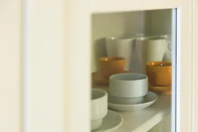 a shelf with cups and bowls on it at Housalia Gracia in Barcelona