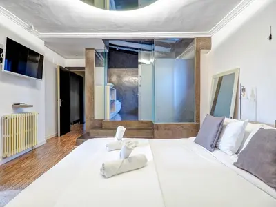 a large white bed with a stuffed animal on it at Villa Nirvana by Hello Homes Sitges in Sitges