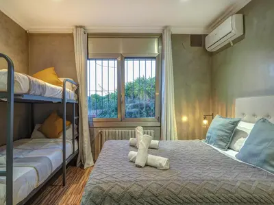 a bedroom with two bunk beds and a teddy bear on a bed at Villa Nirvana by Hello Homes Sitges in Sitges