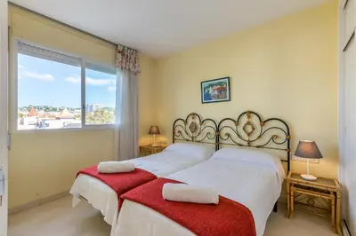 a bedroom with two beds and a window at ESTRELLA DE MAR Sitges in Sitges