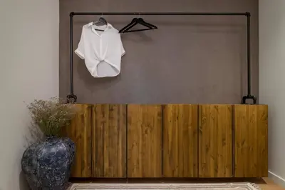 a white shirt hanging on a wall next to a vase at SIERRA - Chic Apartment in Centre of Barcelona in Barcelona