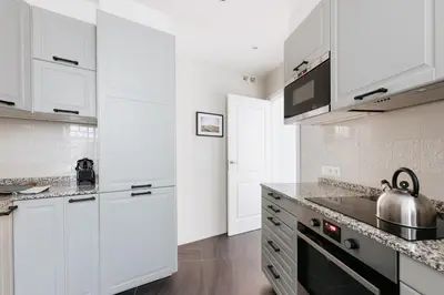 a living room with a green couch and a bedroom at LLANOS - Two Bedroom apartment in heart of the city in Barcelona