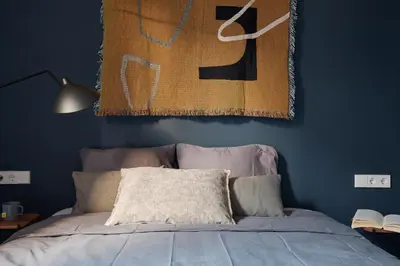 a living room with a bed and a tv and a chair at DENALI - Stylish apartment in center of Barcelona in Barcelona