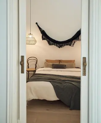 a bedroom with a bed and a living room at SAPO - Two bedroom in the heart of Barcelona in Barcelona