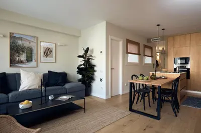 a desk with a laptop and chairs in a room at CASSIS - Two bedroom apartment in Barcelona in Barcelona