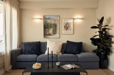 a living room with a blue couch and a table at CASSIS - Two bedroom apartment in Barcelona in Barcelona