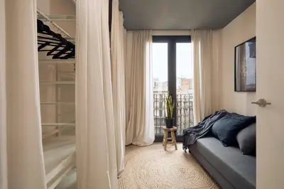 a kitchen with black cabinets and a sink and a mirror at AGAFAY - Two bedroom apartment in Sagrada Familia in Barcelona