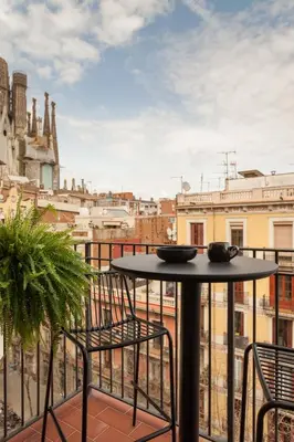 a living room with a couch and a table at NEVIS - Modern two bedroom apartment in Sagrada Familia in Barcelona