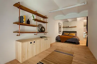 a bedroom with a bed and a wooden floor at AMAZONAS - Three bedroom duplex in Gracia in Barcelona