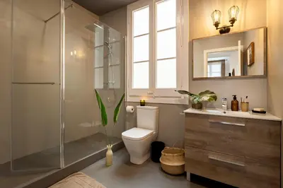 a living room with a large window and a plant at TEFE - Two Bedrooms apartment in Gracia in Barcelona