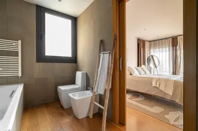 a bathroom with a bed and a toilet and a sink at 4 BR vila 25 minutes to Barcelona Fantastic sea views pool in Alella