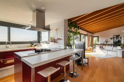 a kitchen with a large island in the middle of a room at 4 BR vila 25 minutes to Barcelona Fantastic sea views pool in Alella