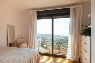 a bedroom with a bed and a large window at 4 BR vila 25 minutes to Barcelona Fantastic sea views pool in Alella