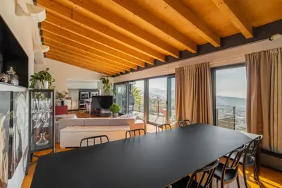 a living room with a large black table and chairs at 4 BR vila 25 minutes to Barcelona Fantastic sea views pool in Alella
