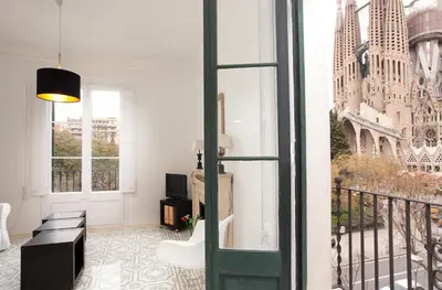 a room with a balcony with a view of the city at Sagrada Familia 4 Bedrooms 