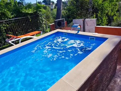 a swimming pool with a table and chairs in a backyard at Relax House Barcelone in Sant Esteve Sesrovires