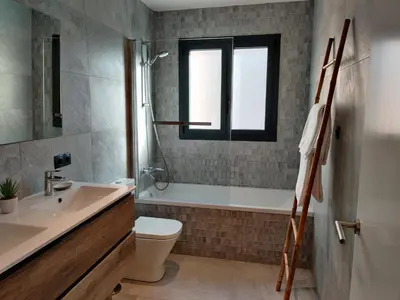 a bathroom with a sink toilet and a window at Stylish apartments Camp Nou in Hospitalet de Llobregat
