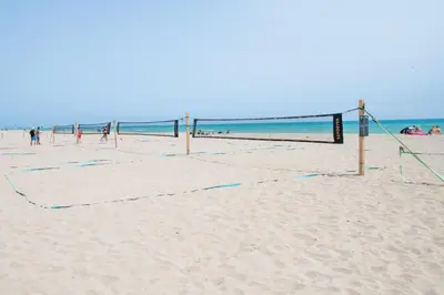 a volley ball net on a sandy beach at Beachfront Sunny Apartment , Sea & Mountain View in Castelldefels