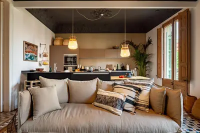 a bedroom with a large bed with a wooden headboard at LEGE - Two bedroom apartment in Mallorca St in Barcelona