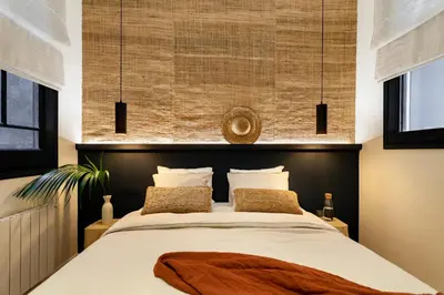 a small bedroom with a bed and a mirror at MILOS - Two bedroom apartment in Mallorca St in Barcelona