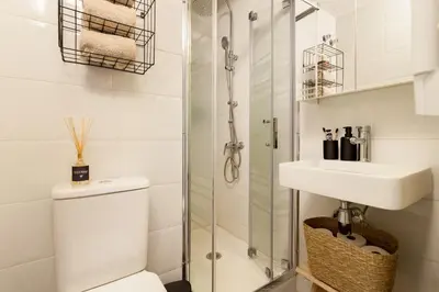 a bed in a room with two pictures on the wall at LEBLON - Two Bedroom Apartment in Eixample in Barcelona