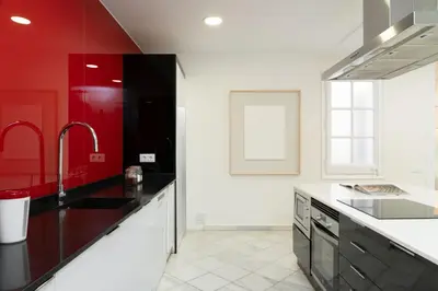 a kitchen with red and white walls and black counter tops at SibsBcn-Paseo de Gracia Luxury Exclusive Gaudí in Barcelona