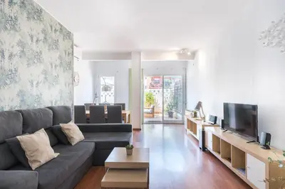 a living room with a couch and a tv at Apartment with terrace a step away from Montjuic, Barcelona in Barcelona