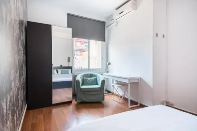a bedroom with a bed and a desk and a chair at Apartment with terrace a step away from Montjuic, Barcelona in Barcelona