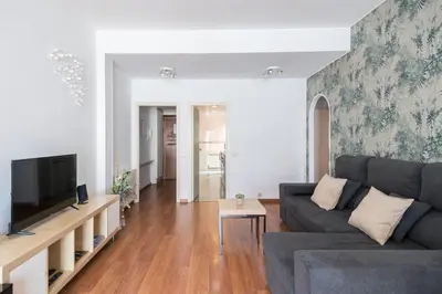 a living room with a couch and a tv at Apartment with terrace a step away from Montjuic, Barcelona in Barcelona