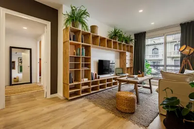 a living room with a couch and a tv at TAMAN - Three Bedroom Apartment in Casanova Street in Barcelona