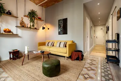 a living room with a yellow couch and a table at NANAY - Two bedroom apartment in Gracia in Barcelona