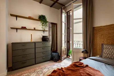 a kitchen with a table and chairs in a room at NANAY - Two bedroom apartment in Gracia in Barcelona