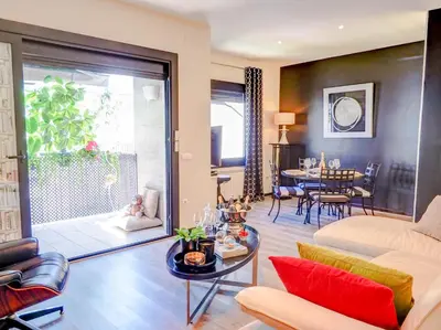 a living room with a couch and a table at Flamingo Apartment by Hello Homes Sitges in Sitges