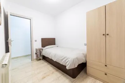 a bedroom with a bed and a large mirror at Mar & Cunit in Cunit