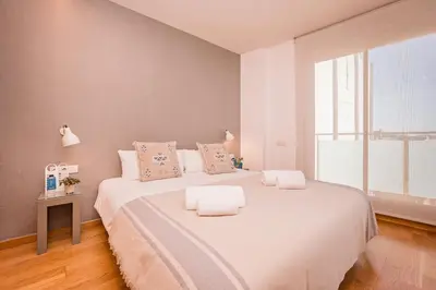 a bedroom with a large white bed with two pillows at Sweett - Jardinets in Barcelona