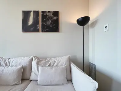 a white couch with three pillows and a black lamp at Stay U-nique Apartments Sants II in Barcelona